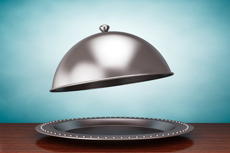 Old Style Photo. Silver Restaurant cloche on the tableの写真素材
