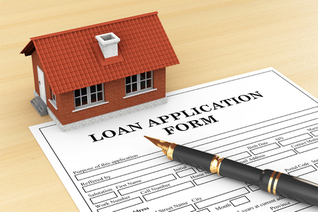Loan Application Form with House and pen on the tableの写真素材
