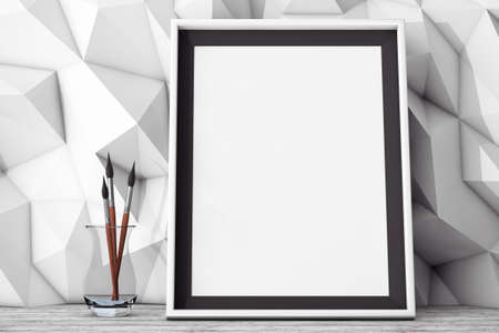 Blank Picture Frame with Brushes in front of Low Polygon Decorative Wall extreme closeup. 3d Renderingの写真素材