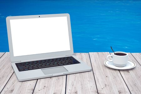 Modern Laptop with Cup of Coffee in front of Ocean extreme closeup. 3d Renderingの写真素材