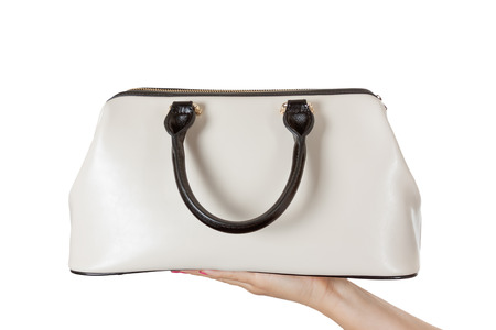 Woman Hand with Cream Coloured Leather Handbag on a white background.の写真素材