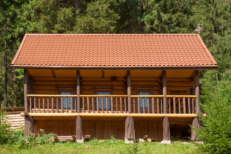 Holiday Apartment Concept. Wooden Cottage in Forest extreme closeupの写真素材