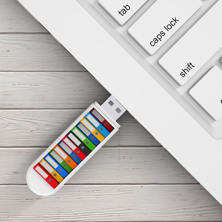 Computer Business Concept. Colorful Office Folders in USB Flash Drive Conected to Laptop on a wooden...