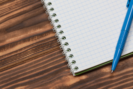 Blank Notebook with Pen on Vintage Rustic Wooden Table Background extreme closeupの写真素材