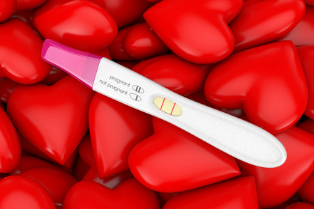 Positive Plastic Pregnancy Test on a Red Hearts Heap Background. 3d Renderingの写真素材