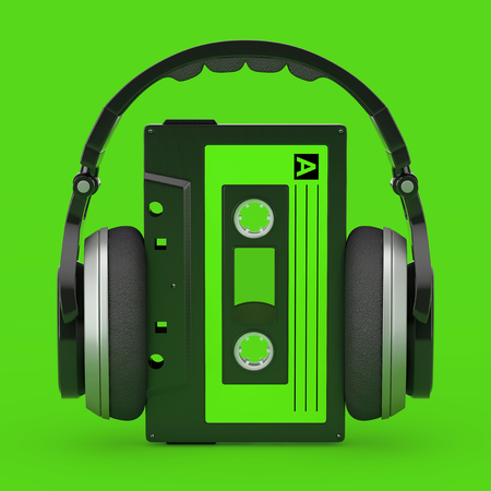 Headphones Over Old Vintage Audio Cassette Tape on a green background. 3d Renderingの写真素材