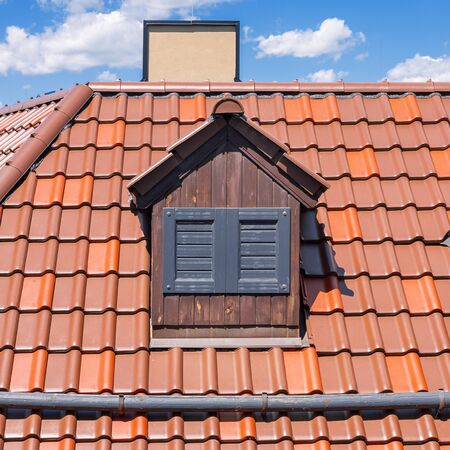 Dutch Red Roof with Dormer and Closed Windows Extreme Closeupの写真素材