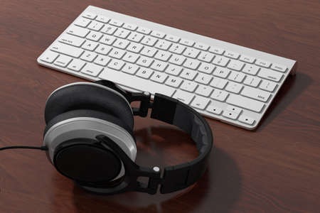Black Headphones with White Computer Keyboard on a wooden table. 3d renderingの写真素材