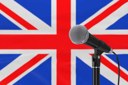 Speech Microphone Stand Against of Blurred Great Britain Flag extreme closeup. 3d renderingの写真素材