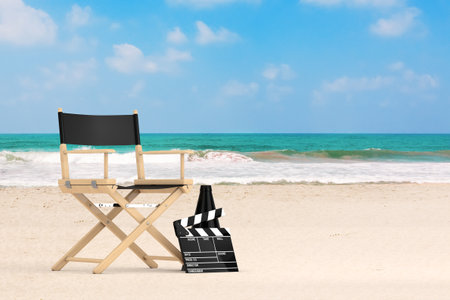 Director Chair, Movie Clapper and Megaphone on an Ocean or Sea Summer Sand Beach background. 3d Renderingの写真素材