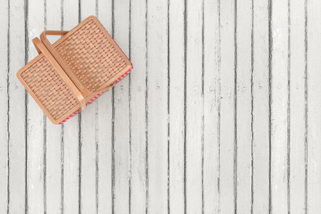Top View of Wicker Picnic Wooden Basket on a white wooden plank background. 3d renderingの写真素材