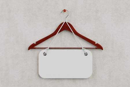 Premium Natural Red Wooden Hangers with Non Slip Bar and Blank Sale Tag with Rope on a White Concrete Wall background. 3d renderingの写真素材