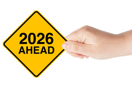 2026 Year Ahead Traffic Sign in Hand on a white background
