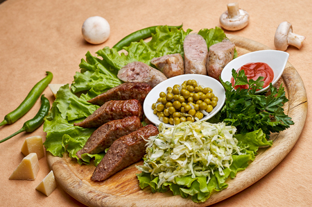 Fried sausage with green peas and ketchupの写真素材