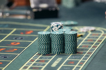 Detail of a green roulette table with some numbers.