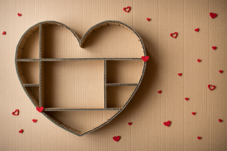 Heart-shaped shadow box hand-made of corrugated on cardboard backgroundの写真素材