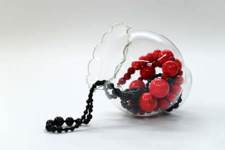 Red and black shining beads in a glass bowlの写真素材