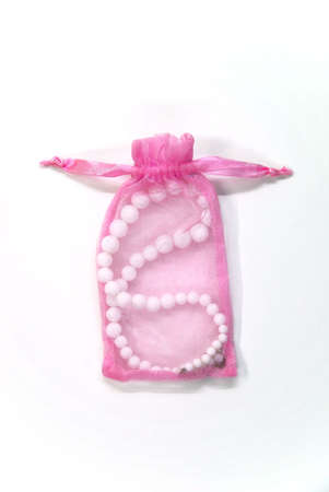 small pink bag with pearl on a white backgroundの写真素材