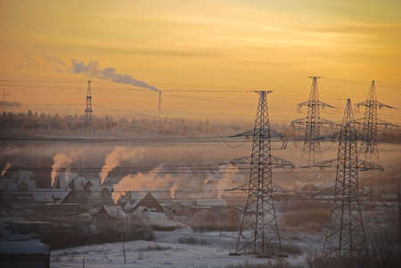 billowing smoke into the atmosphere at frozen sunsetの写真素材