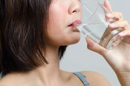 Girl drinking clean fresh water with glassのeditorial素材