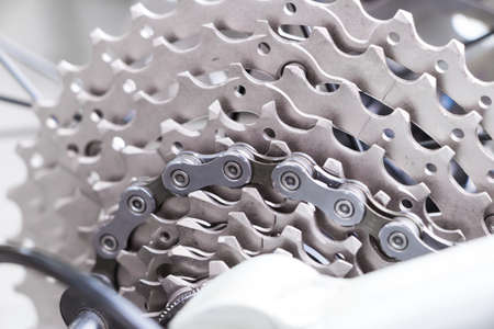 Mountain bike wheel and gear detailing a new clean chain and metal chain rings