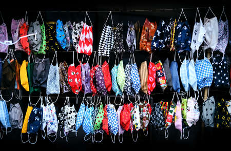 Variety of colorful new handmade cotton cloth face masks. Reusable multicolored protective fabric mouth-nose masks against coronavirus, covid-19 or flu. Prevent germs with fashionable design masks.のeditorial素材