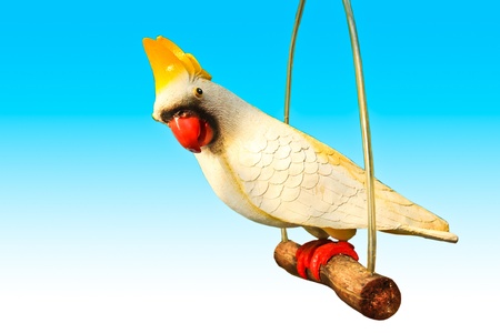 Colorful wooden statuette of a parrot isolated.の写真素材