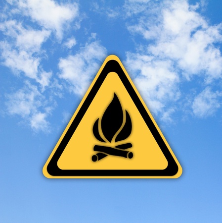 Glossy Fire danger sign on beautiful sky background.の写真素材