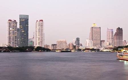 Buildings along the river at sunset. The view from Asiatique. Attractions in Bangkok, Thailand.