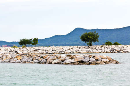 Breakwall rocks at sea coast in Thailand.の写真素材