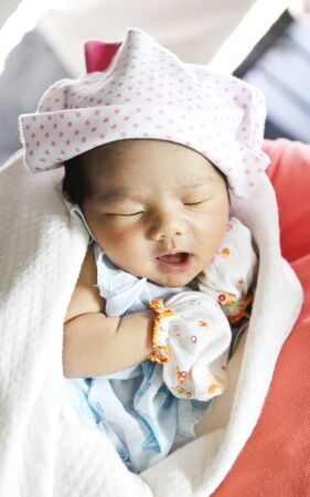 Newborn Asian baby girl sleepingの写真素材