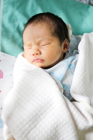 Newborn asian baby girl in hospitalの写真素材