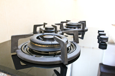 Black glass gas hob in kitchen