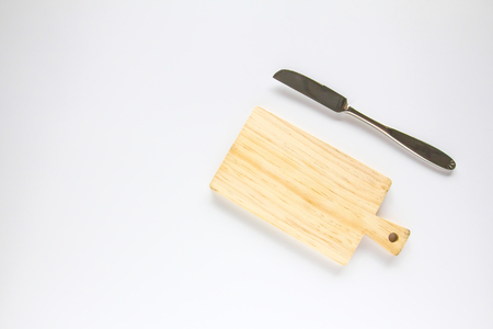 Wooden chopping board and knife on white backgroundの写真素材