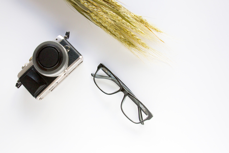 Camera and glasses on white background.の写真素材