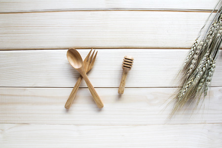 Wooden kitchen utensils on wooden backgroundの写真素材