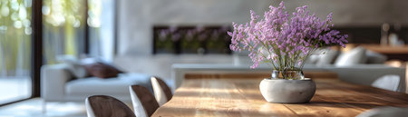 Cozy and welcoming modern dining area featuring a wooden table plush chairs and a beautiful bouquet of blooming desert sand verbena flowers in a minimalist vaseの素材