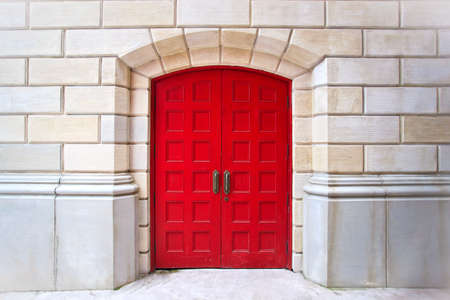 Red door on white brick backgroundの写真素材