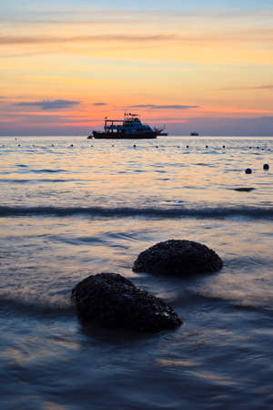 sunset sea and boat as backgroundの写真素材
