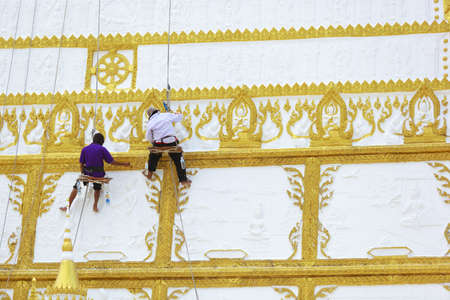 2 men are painting a wallの写真素材