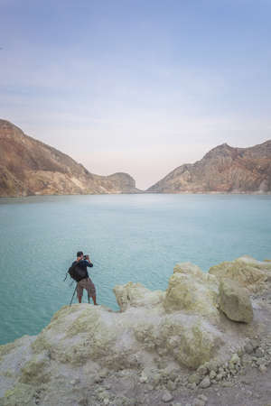 Photographer take a sea and mountain shotの写真素材
