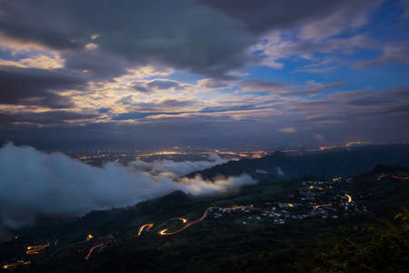 Night mountain cityscape road with fogの写真素材