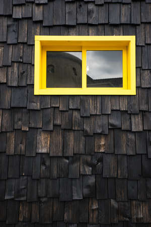 Yellow window on wooden texture backgroundの写真素材