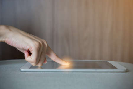 Finger point to the tabletの写真素材