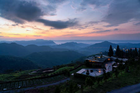 Mountain sunrise twilight with a home at frontの写真素材