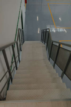 Stairs in a car workshop with exit markings