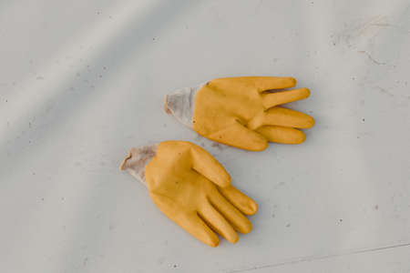 Protective gloves thrown on the roof after finish workの写真素材
