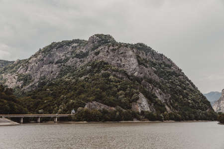 Dam located on the river and a road bridge.High mountains between which a river flowsの写真素材