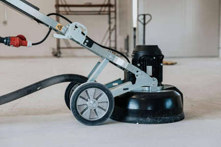 machine polishing surface floor smoothing and finishing hardener or epoxy concrete in the factoryの写真素材