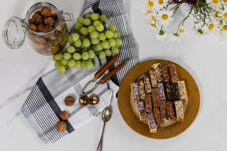 Assorted homemade cakes stage with grapes and nuts. Top view, flat layの写真素材